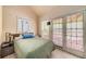 Cozy bedroom featuring a bed with French doors leading to an outdoor patio at 5917 Southland Dr, Stone Mountain, GA 30087