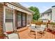 Inviting outdoor deck with comfortable seating, patio table, and mature landscaping at 5917 Southland Dr, Stone Mountain, GA 30087