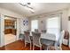 Light-filled dining room features wood floors and modern lighting fixture at 5917 Southland Dr, Stone Mountain, GA 30087