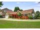 Brick home featuring a two car garage, covered patio and mature trees at 5917 Southland Dr, Stone Mountain, GA 30087