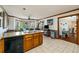Bright kitchen featuring granite counters, tile floor and stainless steel appliances at 5917 Southland Dr, Stone Mountain, GA 30087