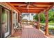 Wonderful covered patio with comfortable seating, mature trees and brick elements at 5917 Southland Dr, Stone Mountain, GA 30087