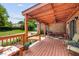 Relaxing covered patio with comfortable seating, mature trees and brick elements at 5917 Southland Dr, Stone Mountain, GA 30087