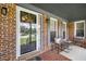 Inviting porch with brick flooring, seating area, and views of the front yard and neighborhood at 5917 Southland Dr, Stone Mountain, GA 30087