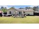 Large backyard featuring a patio with outdoor seating and mature trees at 1150 Bonita Cir, Jonesboro, GA 30238