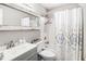 Neutral bathroom with a shower-tub combo, decorative shower curtain, and framed mirror at 1150 Bonita Cir, Jonesboro, GA 30238
