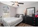 Well-lit bedroom featuring a comfortable bed, dresser with mirror, and large window at 1150 Bonita Cir, Jonesboro, GA 30238