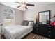Cozy bedroom features wood-look flooring, a ceiling fan, and a large window at 1150 Bonita Cir, Jonesboro, GA 30238