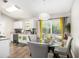 Bright dining area with a glass table, seating for four, and natural light from the sliding glass door at 1150 Bonita Cir, Jonesboro, GA 30238