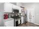 Modern kitchen equipped with stainless steel appliances and sleek white cabinetry at 1150 Bonita Cir, Jonesboro, GA 30238