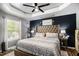 Comfortable main bedroom with a large bed, tray ceiling, and modern decor at 1150 Bonita Cir, Jonesboro, GA 30238