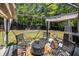 Outdoor patio area with comfortable seating, a fire pit, and a relaxing hammock at 1150 Bonita Cir, Jonesboro, GA 30238