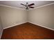 A bedroom with wood floors, white trim, and a ceiling fan at 1167 Drewsbury Ct, Smyrna, GA 30080