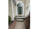 Close up of a front door with arched window feature, and stone steps at 1167 Drewsbury Ct, Smyrna, GA 30080