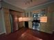 Well-lit kitchen with stainless steel appliances, wood cabinets and granite countertops at 1167 Drewsbury Ct, Smyrna, GA 30080