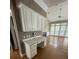 Modern open concept kitchen with island, adjacent built-in desk and lots of cabinetry at 1167 Drewsbury Ct, Smyrna, GA 30080