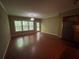 Spacious living room featuring a ceiling fan, wood floors, and lots of natural light from the windows at 1167 Drewsbury Ct, Smyrna, GA 30080