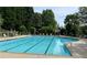 Community pool with lounge chairs surrounded by mature trees at 1167 Drewsbury Ct, Smyrna, GA 30080