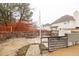 Unkempt backyard featuring a volleyball court, a weathered fence and retaining wall, and patchy grass at 1439 Alice Ave, Lithonia, GA 30058