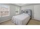 Bedroom featuring two windows, a fireplace in the headboard, and neutral decor at 1439 Alice Ave, Lithonia, GA 30058