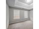 Bright bedroom with tray ceiling and carpet, plus two windows offering plenty of natural light at 1439 Alice Ave, Lithonia, GA 30058