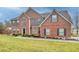 Classic brick home with well-manicured lawn, complemented by manicured landscaping and a welcoming entrance at 1439 Alice Ave, Lithonia, GA 30058