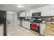 Stylish kitchen boasts granite counters, stainless steel appliances, mosaic backsplash, and seamless flow to dining at 1439 Alice Ave, Lithonia, GA 30058