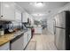 Updated kitchen features granite counters, stainless steel appliances, mosaic backsplash, and an island with seating at 1439 Alice Ave, Lithonia, GA 30058