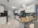 Bright kitchen with granite counters, stainless steel appliances, a mosaic backsplash, and stylish island seating at 1439 Alice Ave, Lithonia, GA 30058