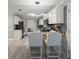 Stylish kitchen features granite counters, a mosaic backsplash, stainless appliances, and an island with seating at 1439 Alice Ave, Lithonia, GA 30058
