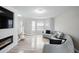 Cozy living room featuring a modern fireplace, television, and natural light at 1439 Alice Ave, Lithonia, GA 30058