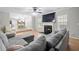 Comfortable living area with a fireplace, flat screen tv and views into kitchen and dining spaces at 1439 Alice Ave, Lithonia, GA 30058