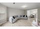 Modern living room featuring unique seating and wood flooring, with an open concept view to the dining room at 1439 Alice Ave, Lithonia, GA 30058