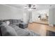 Spacious living room flows into the kitchen area with seating and a gray sectional sofa and chair at 1439 Alice Ave, Lithonia, GA 30058