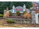 Neighborhood entrance sign featuring stone pillars and lush landscaping, showcasing the community's identity at 1439 Alice Ave, Lithonia, GA 30058