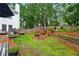Enjoy this backyard with a fire pit, wooden fence, garden area, and a spacious deck at 1825 Crescent Rdg, Cumming, GA 30041