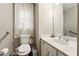 Cozy bathroom with a toilet, sink, and small window at 1825 Crescent Rdg, Cumming, GA 30041