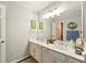 Bathroom boasts double sink vanity with white cabinetry, large mirror, and modern lighting fixtures at 1825 Crescent Rdg, Cumming, GA 30041