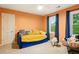 Bright bedroom with carpet floors, daybed, natural light from two windows, and colorful decor at 1825 Crescent Rdg, Cumming, GA 30041