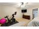 This bedroom features carpeted floors, neutral walls, a ceiling fan, and ample space for exercise equipment at 1825 Crescent Rdg, Cumming, GA 30041