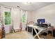 Bright bedroom with carpet, white walls, two windows, and a dedicated workspace at 1825 Crescent Rdg, Cumming, GA 30041