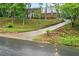 Classic two-story brick home featuring a long driveway and well-maintained front yard at 1825 Crescent Rdg, Cumming, GA 30041