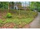 Charming two-story brick home with a well-manicured lawn and mature trees at 1825 Crescent Rdg, Cumming, GA 30041
