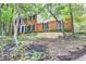 Traditional two-story brick home surrounded by mature trees and lush landscaping at 1825 Crescent Rdg, Cumming, GA 30041