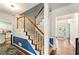 Inviting foyer with stairs, adjacent kitchen, and front door at 1825 Crescent Rdg, Cumming, GA 30041