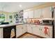 Open kitchen with white cabinets, laminate countertops, and a breakfast nook at 1825 Crescent Rdg, Cumming, GA 30041