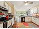 Well-lit kitchen with white cabinets, tile backsplash, and stainless steel appliances at 1825 Crescent Rdg, Cumming, GA 30041