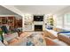 Comfortable living room featuring a fireplace, built-in shelving, and lots of seating at 1825 Crescent Rdg, Cumming, GA 30041