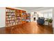 Warm and inviting living room featuring hardwood floors, a fireplace, and built-in bookshelves at 1825 Crescent Rdg, Cumming, GA 30041