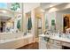 Bright bathroom with walk-in shower, soaker tub, and and sinks at 1825 Crescent Rdg, Cumming, GA 30041